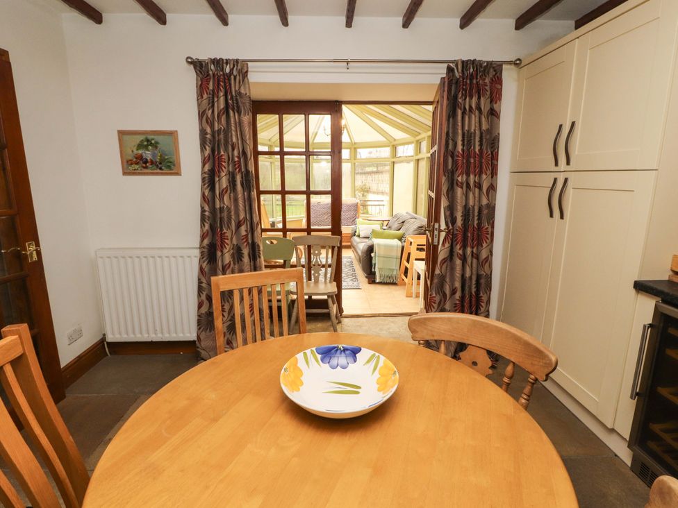 A dining room with a wooden table and chairs at High Mill House Penrith