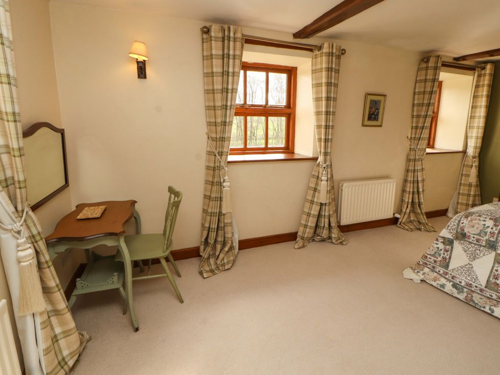 A bedroom with a desk and chair at High Mill House in Penrith