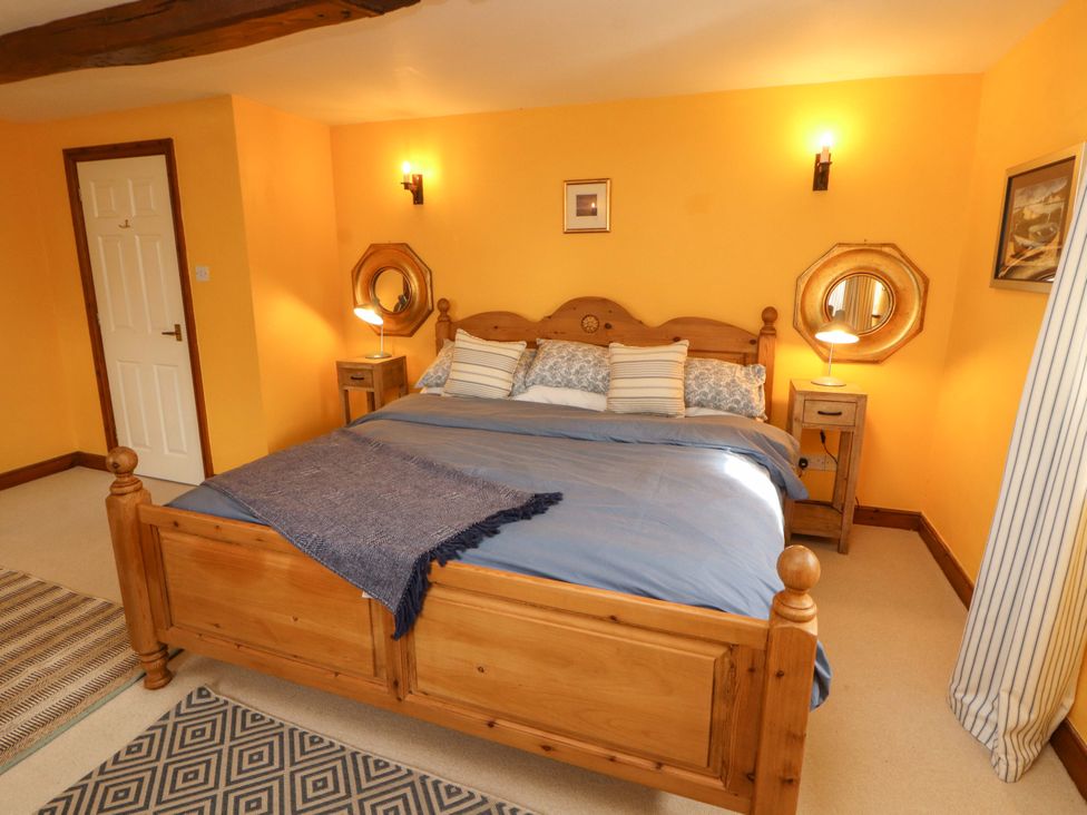 A bedroom with a bed and nightstand at High Mill House in Penrith