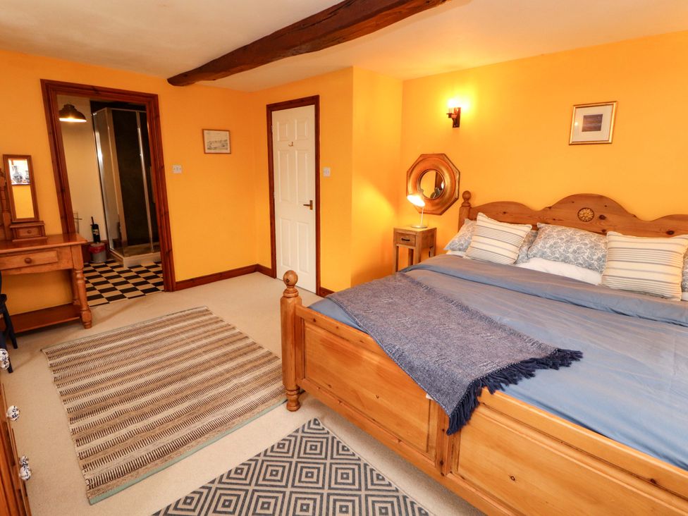 A bedroom with a bed and a dresser at High Mill House in Penrith
