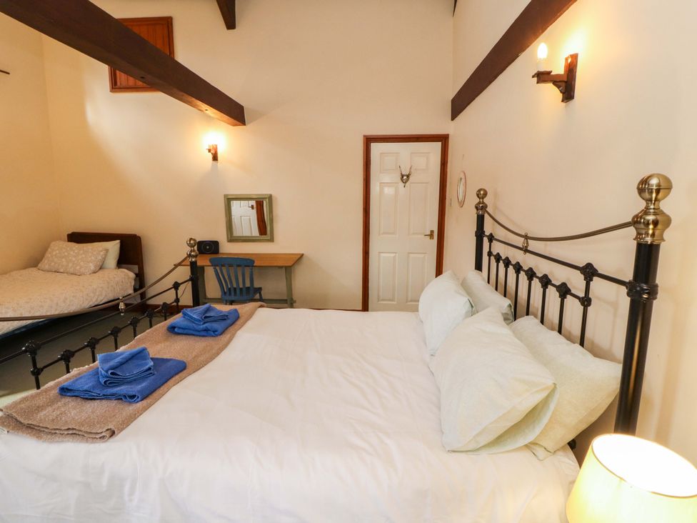 A bedroom with a double bed and a single bed at High Mill House in Penrith