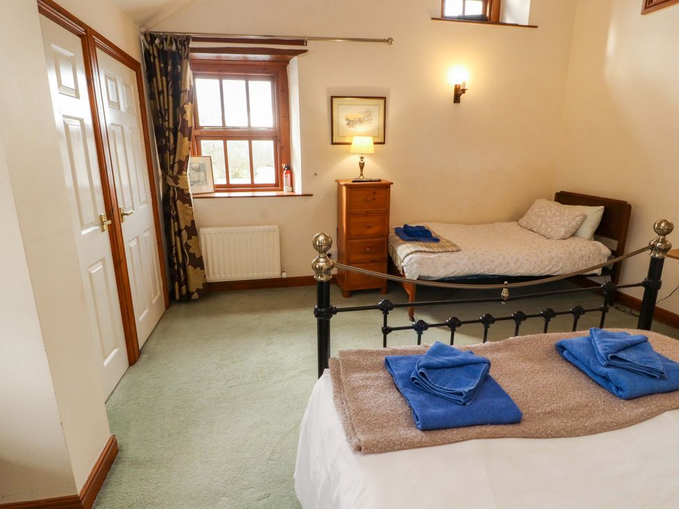 A bedroom with a bed and a single bed at High Mill House in Penrith