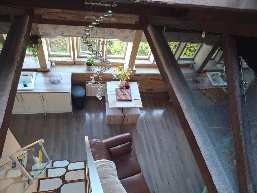 A kitchen with a table and chairs at Riverview Cottage in Holmfirth
