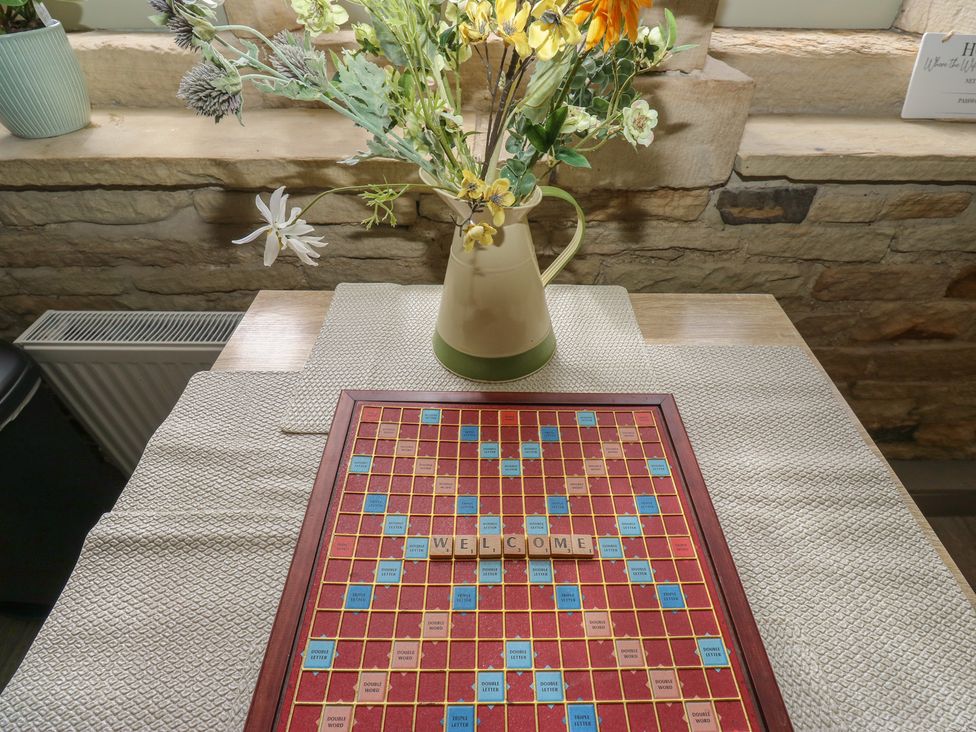 A scrabble board with letters on a table at Riverview Cottage in Holmfirth
