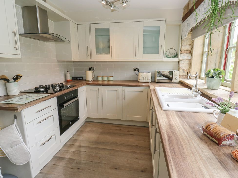 A kitchen with appliances and utensils at Riverview Cottage in Holmfirth
