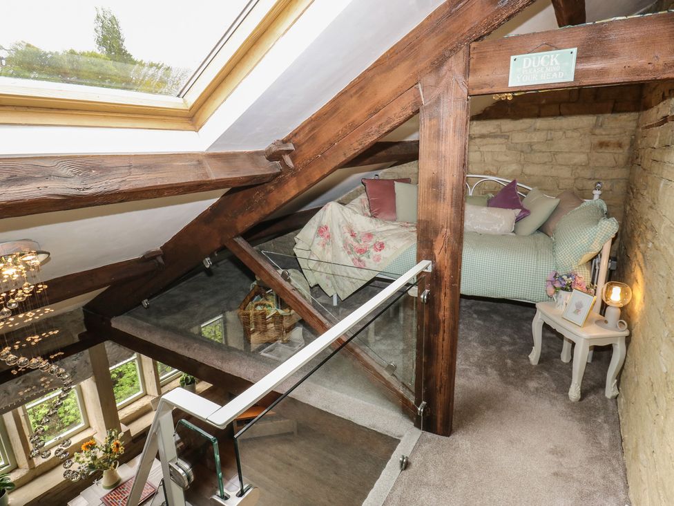 A bedroom with a bed and side table at Riverview Cottage in Holmfirth