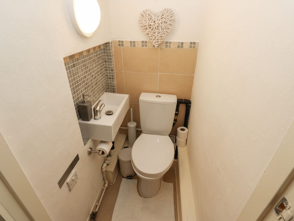 A bathroom with a toilet and sink at Riverview Cottage in Holmfirth