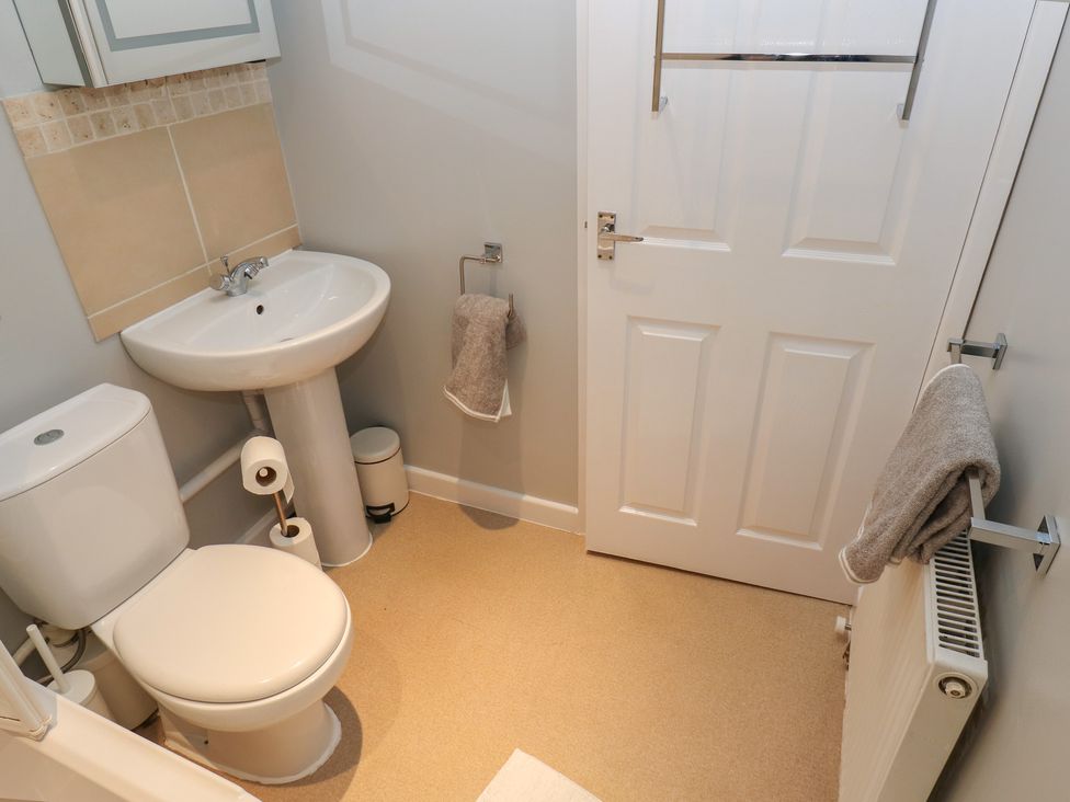 A bathroom with a toilet and sink at Riverview Cottage in Holmfirth