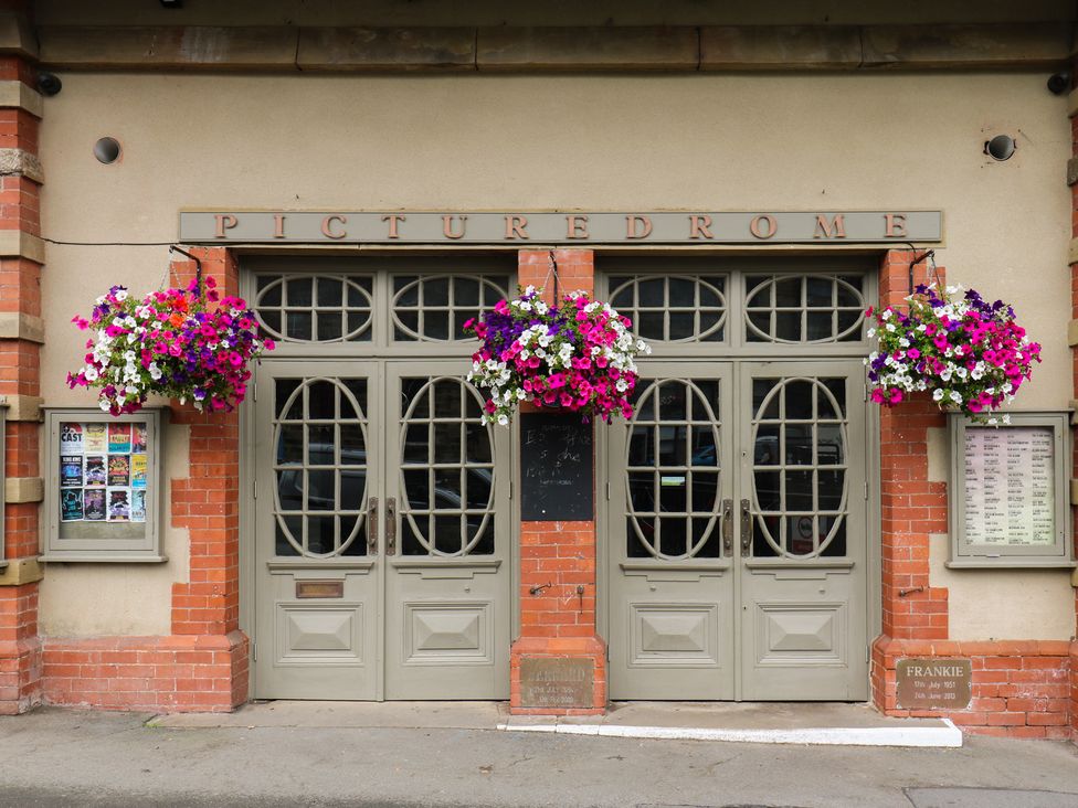 An entrance to Picturedrome with flower baskets at Riverview Cottage Holmfirth