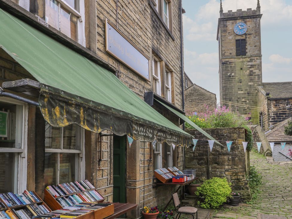 A book display outside a shop with a clock tower in the background at Riverview Cottage Holmfirth