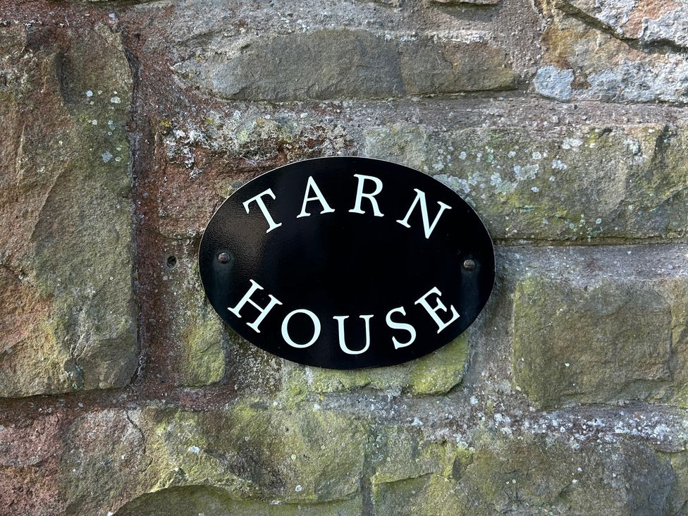 A nameplate on a stone wall at Tarn House in Hawes
