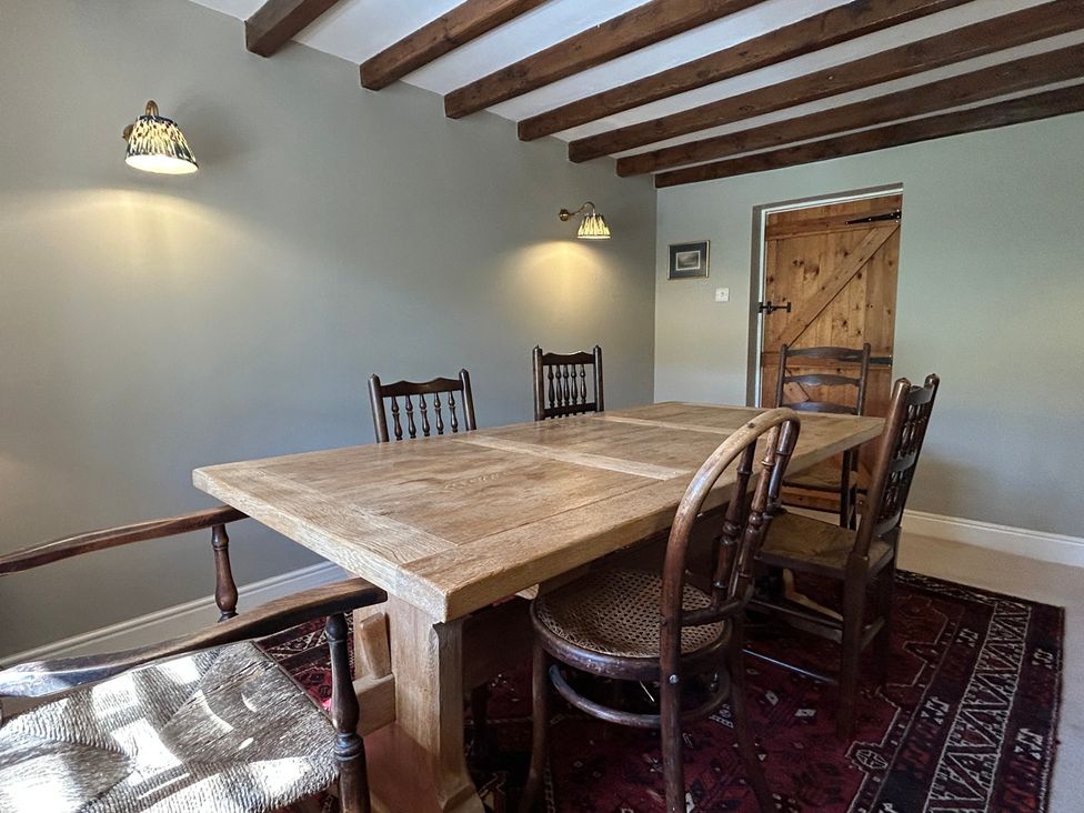 A dining room with a table and chairs at Tarn House in Hawes