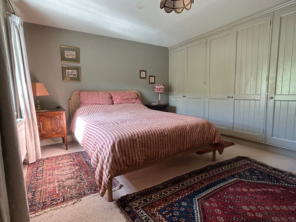 A bedroom with a bed and wardrobe at Tarn House in Hawes