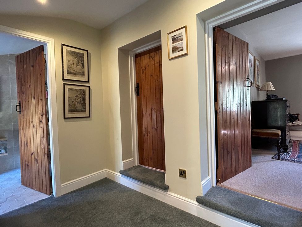 A hallway with wooden doors and frames at Tarn House in Hawes