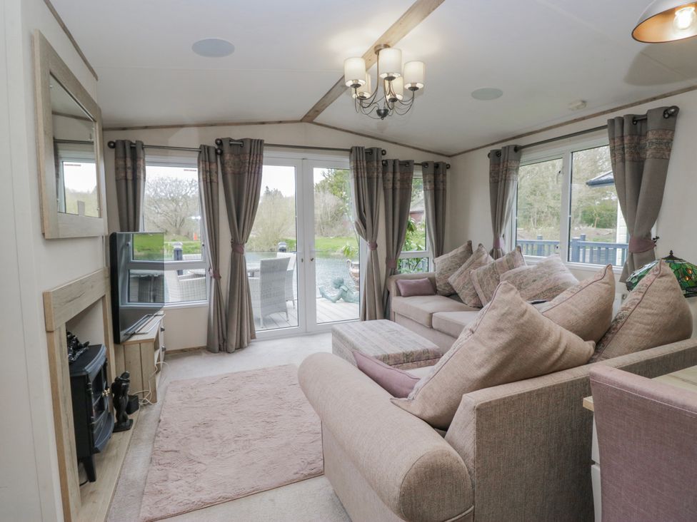 A living room with a sofa and television at Carp Lodge 