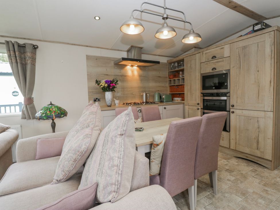 A kitchen with a dining table and chairs at Carp Lodge