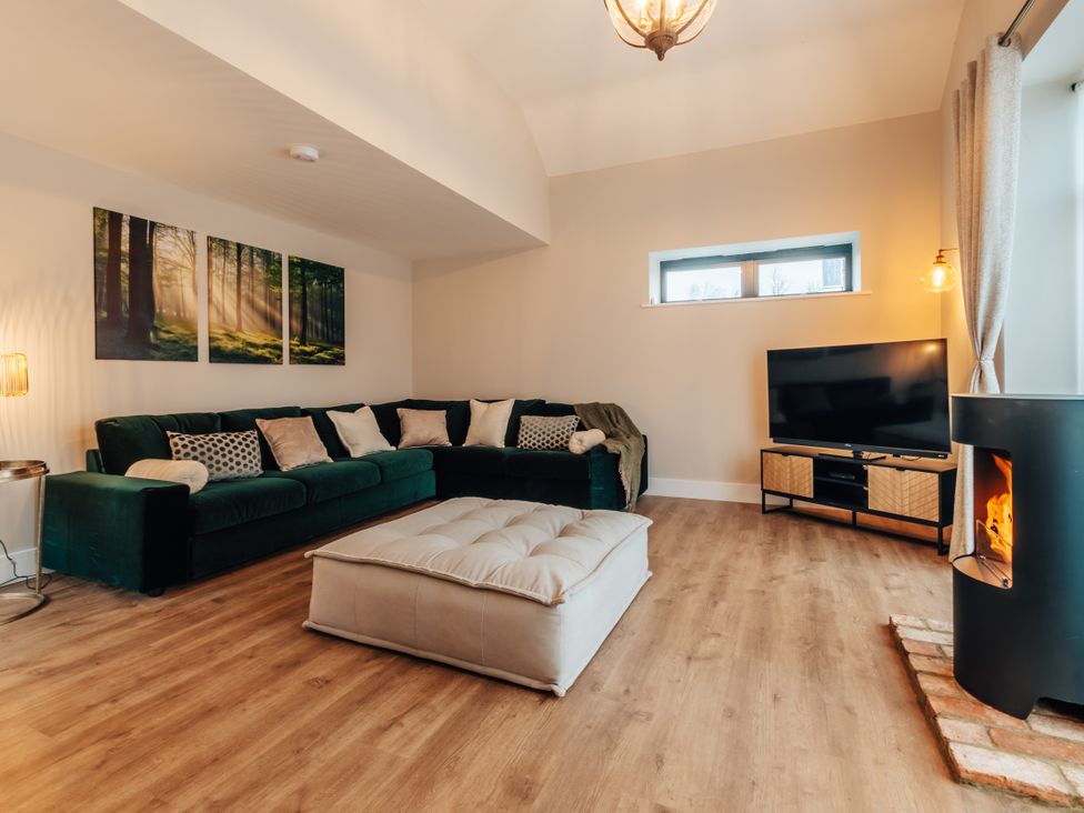 A living room with a sofa and coffee table at The Stables in Catworth