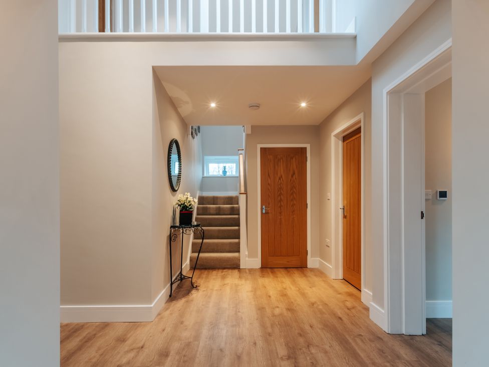 A hallway with stairs and doors at The Stables in Catworth