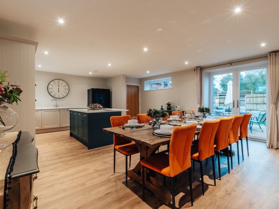 A dining room with a table and chairs at The Stables in Catworth