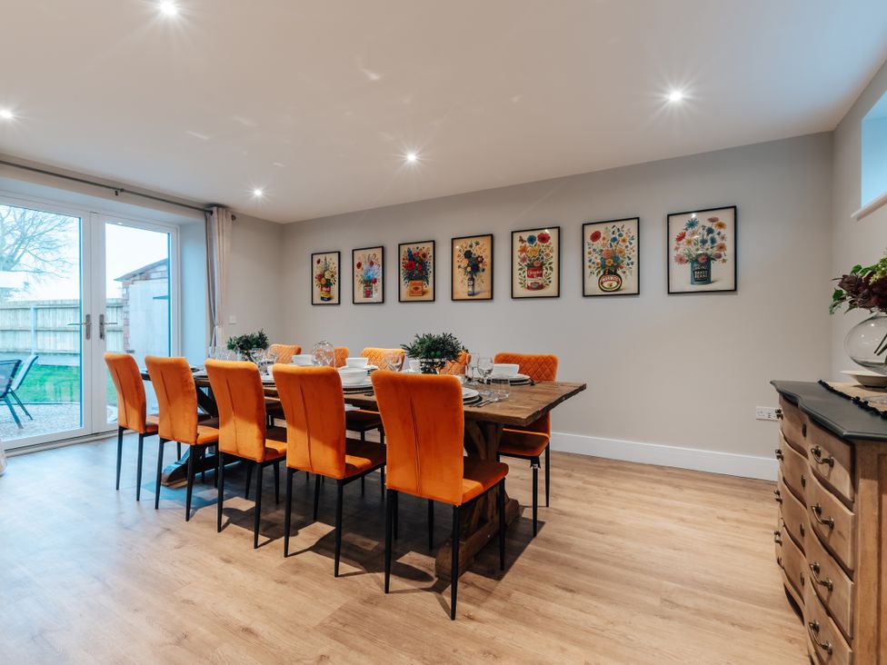 A dining room with a table and chairs at The Stables in Catworth