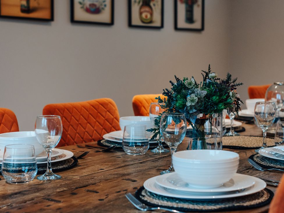 A dining room with a table set for dinner at The Stables in Catworth