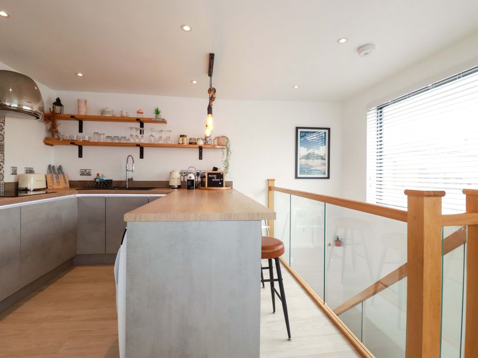 A kitchen with a countertop and bar stool at La Casita in Newquay