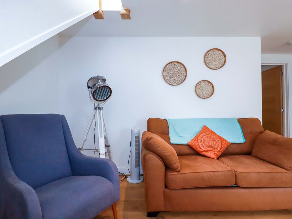 A living room with a sofa and armchair at La Casita in Newquay