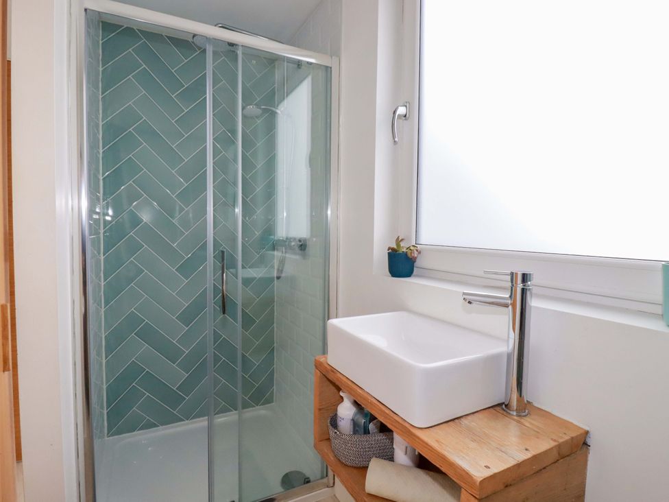 A bathroom with a shower and sink at La Casita in Newquay