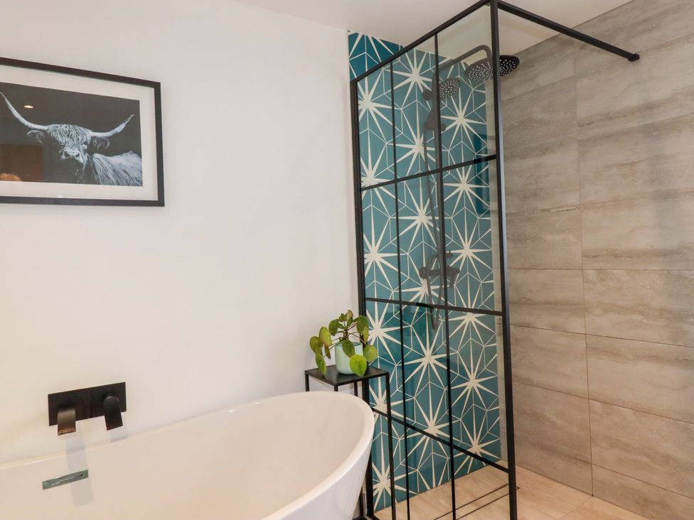 A bathroom with a bathtub and shower at La Casita in Newquay