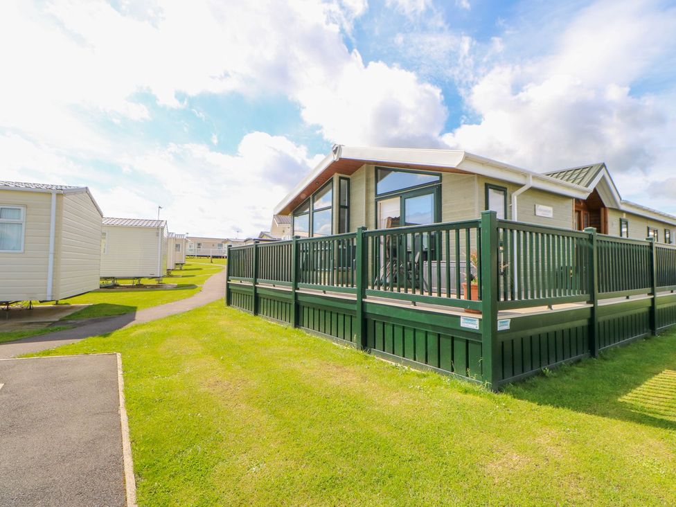A park home with decking and grass area at 37 Horizon Park in Hartlepool