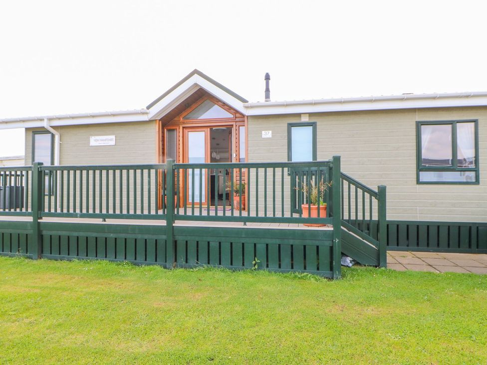 A front view of a property with a deck and potted plants at 37 Horizon Park in Hartlepool