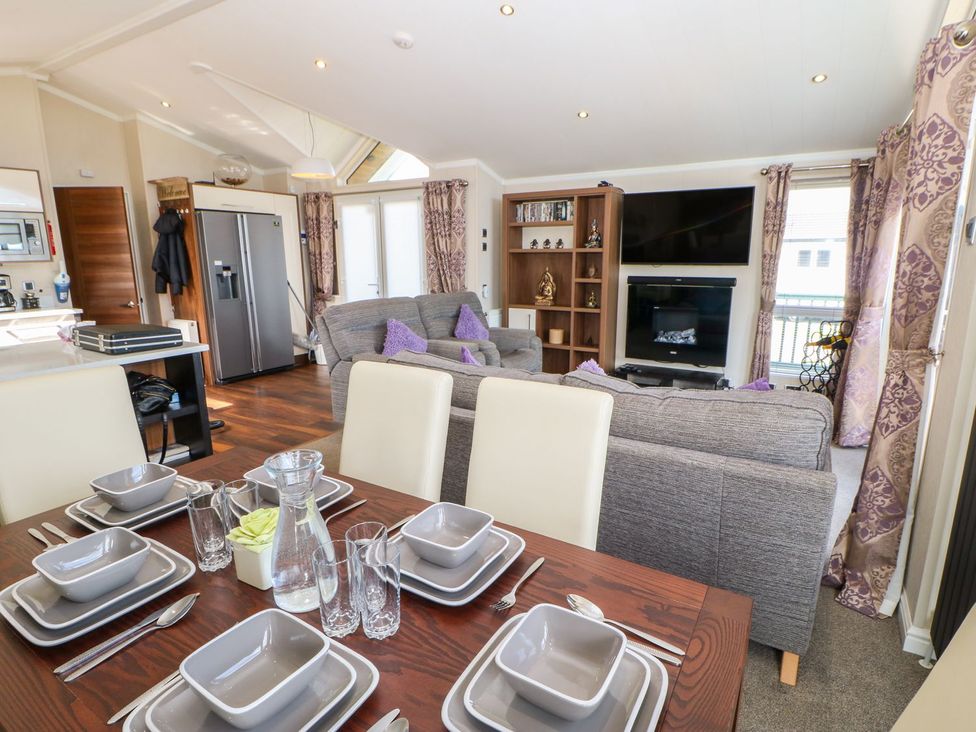 A dining room with a table set for meals at 37 Horizon Park in Hartlepool