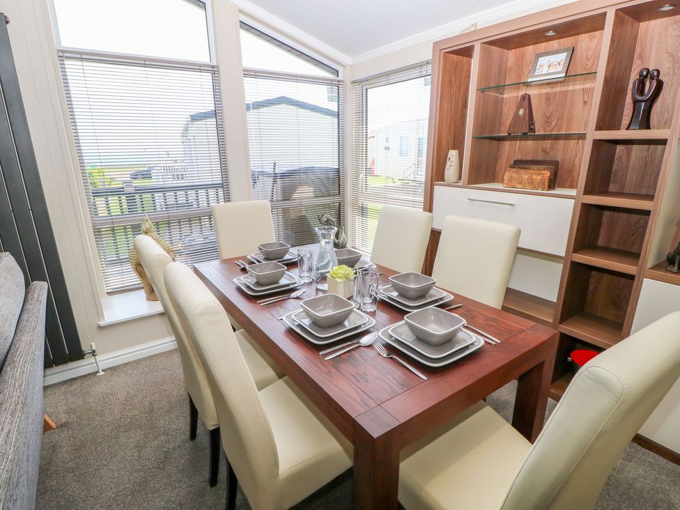 A dining room with a table set for meals at 37 Horizon Park in Hartlepool
