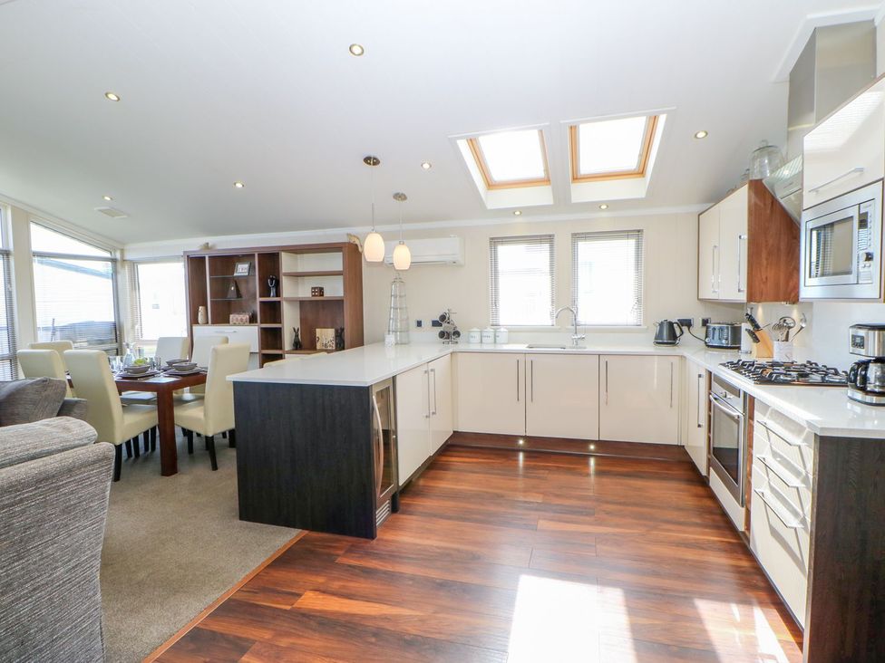 A kitchen with an island and dining area at 37 Horizon Park in Hartlepool