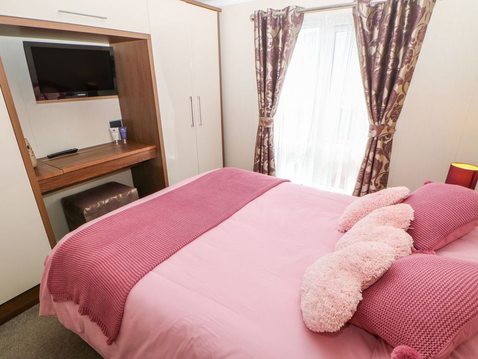 A bedroom with a bed and television at 37 Horizon Park in Hartlepool