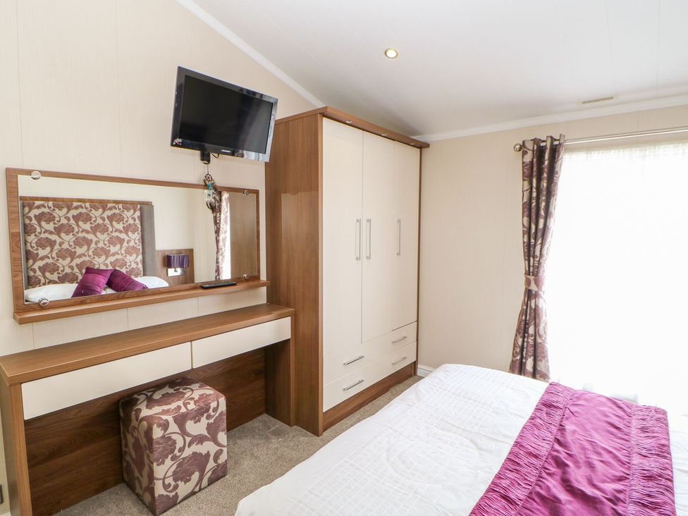 A bedroom with a bed and a television at 37 Horizon Park in Hartlepool