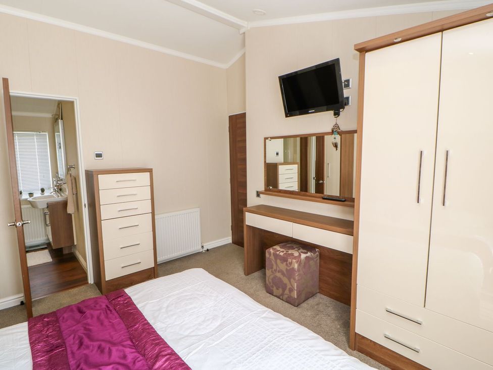 A bedroom with a bed and wardrobe at 37 Horizon Park in Hartlepool