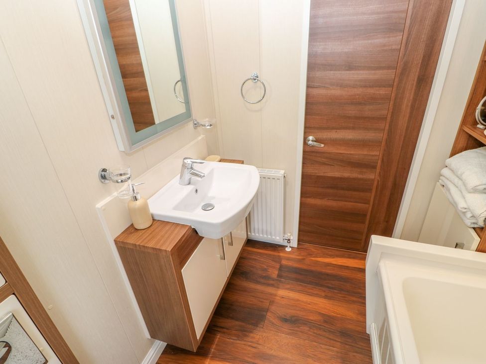 A bathroom with a sink and mirror at 37 Horizon Park in Hartlepool