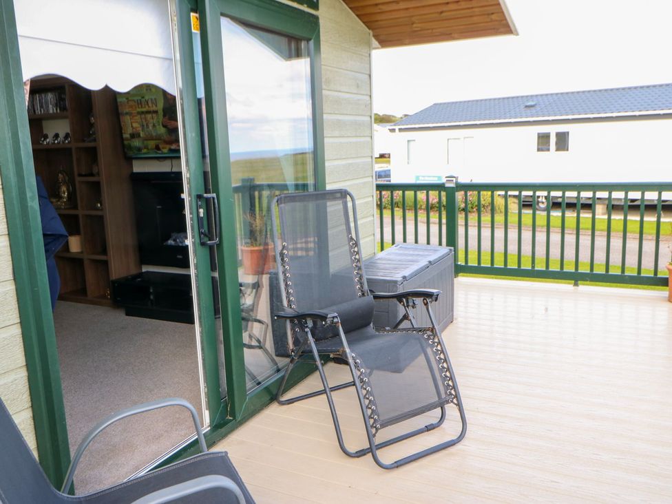 An outdoor area with chairs and a table at 37 Horizon Park in Hartlepool