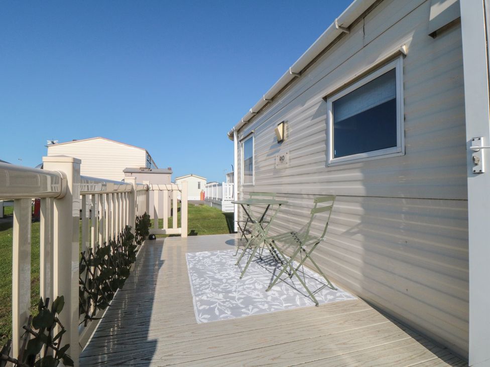 An outdoor area with a table and chairs at Caravan 132 in Redcar