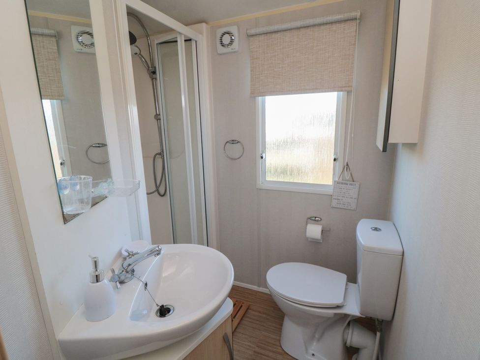 A bathroom with sink, shower, and toilet at Caravan 132 Redcar