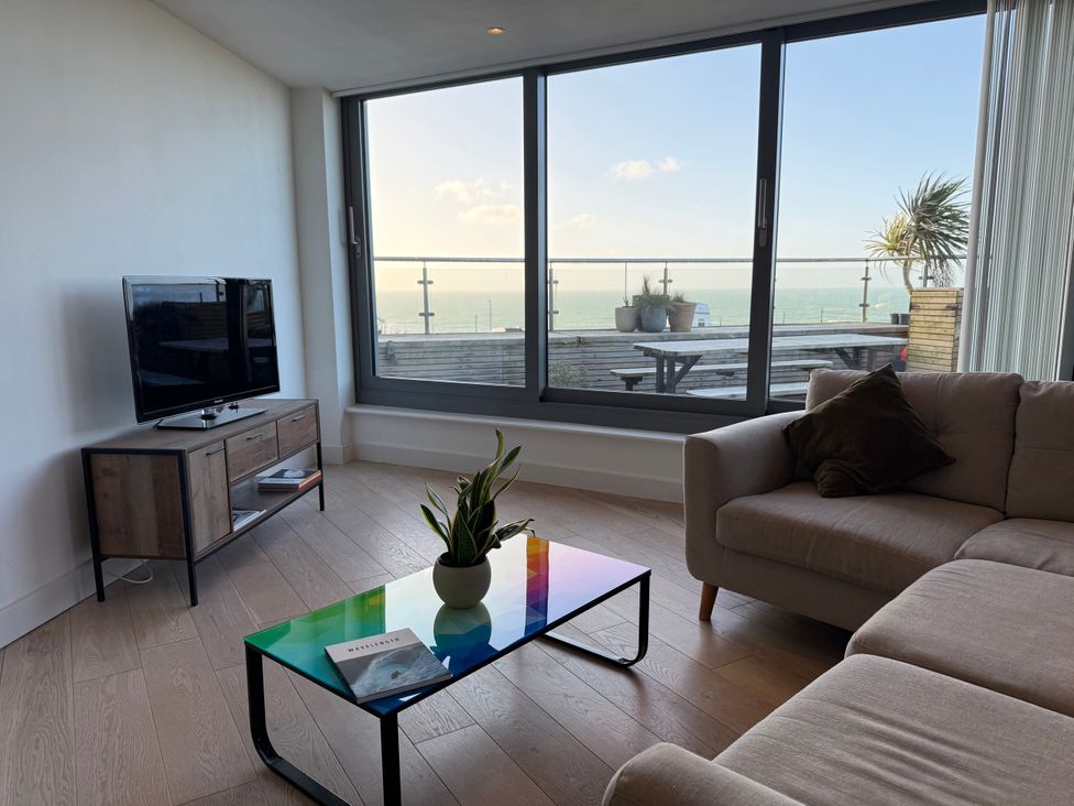 A living room with a television and coffee table at Apartment 29 in Newquay
