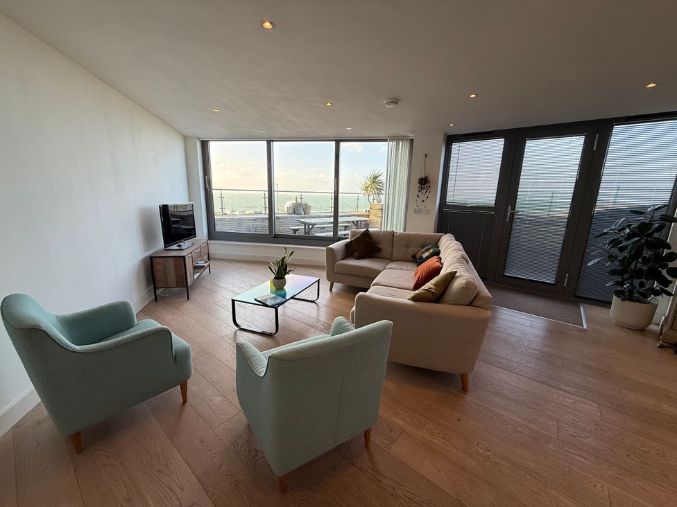 A living room with a sofa and armchairs at Apartment 29 in Newquay