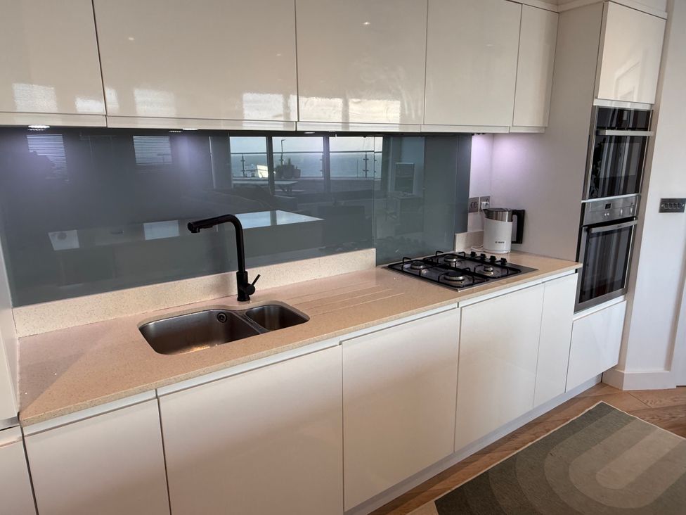 A kitchen with a sink and gas stove at Apartment 29 in Newquay