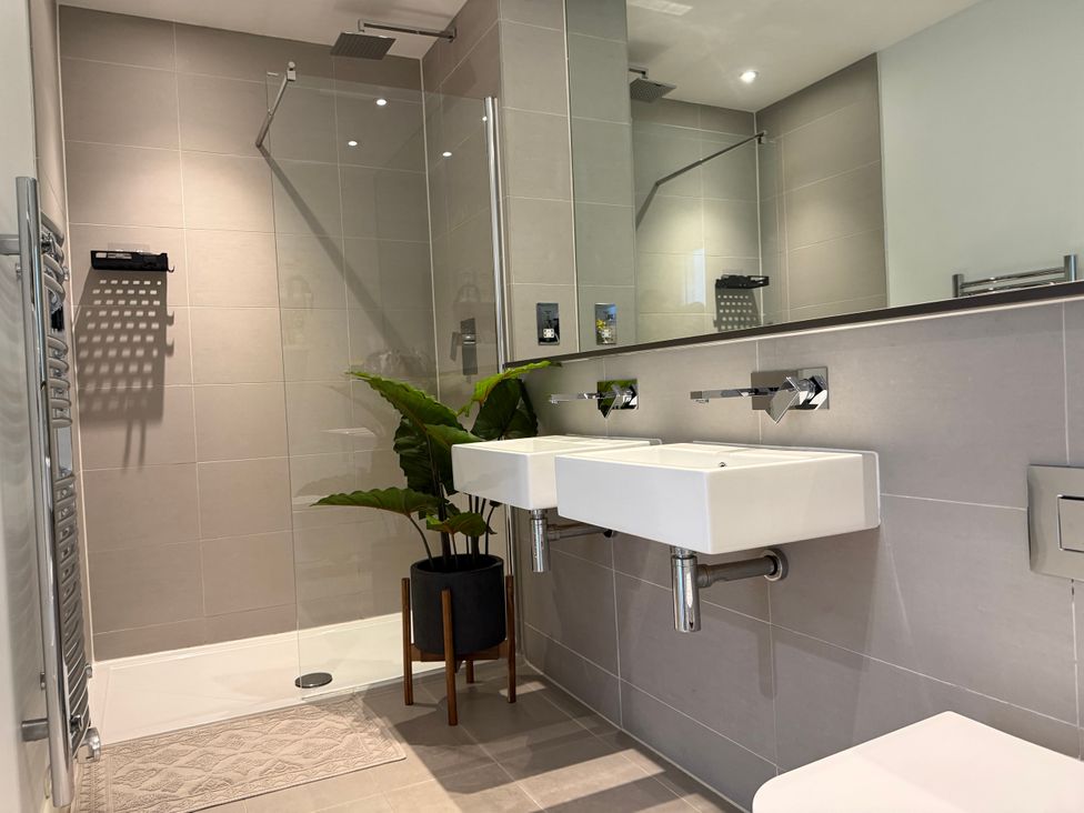 A bathroom with two sinks and a shower at Apartment 29 in Newquay