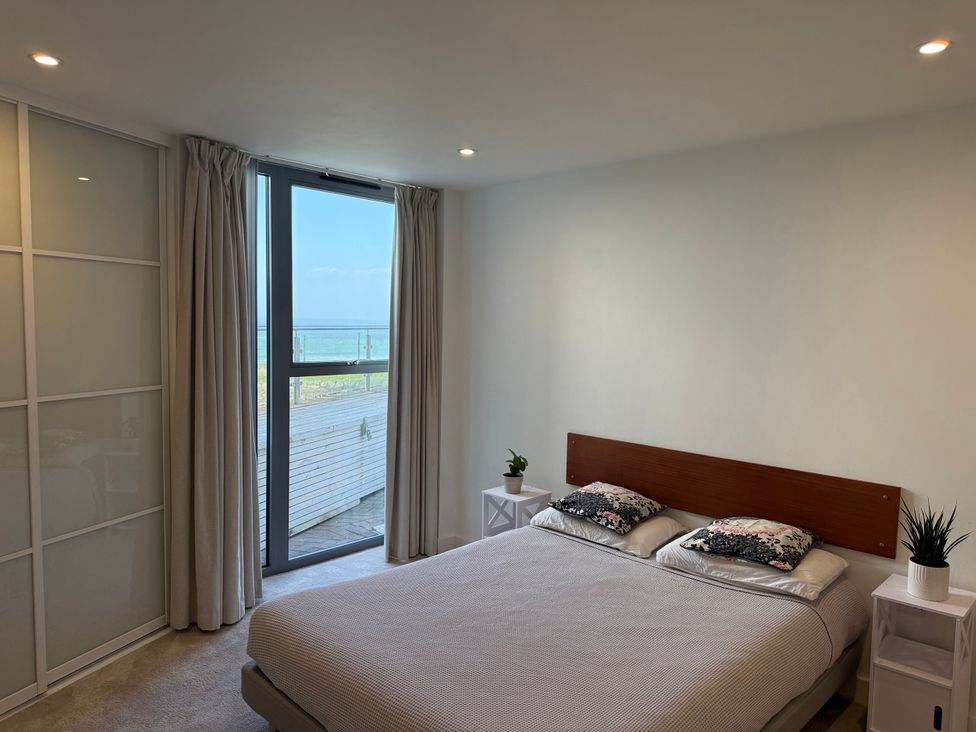 A bedroom with a bed and window at Apartment 29 in Newquay