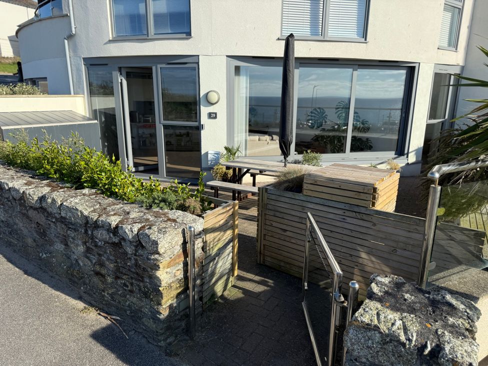 An outdoor patio with tables and chairs at Apartment 29 in Newquay
