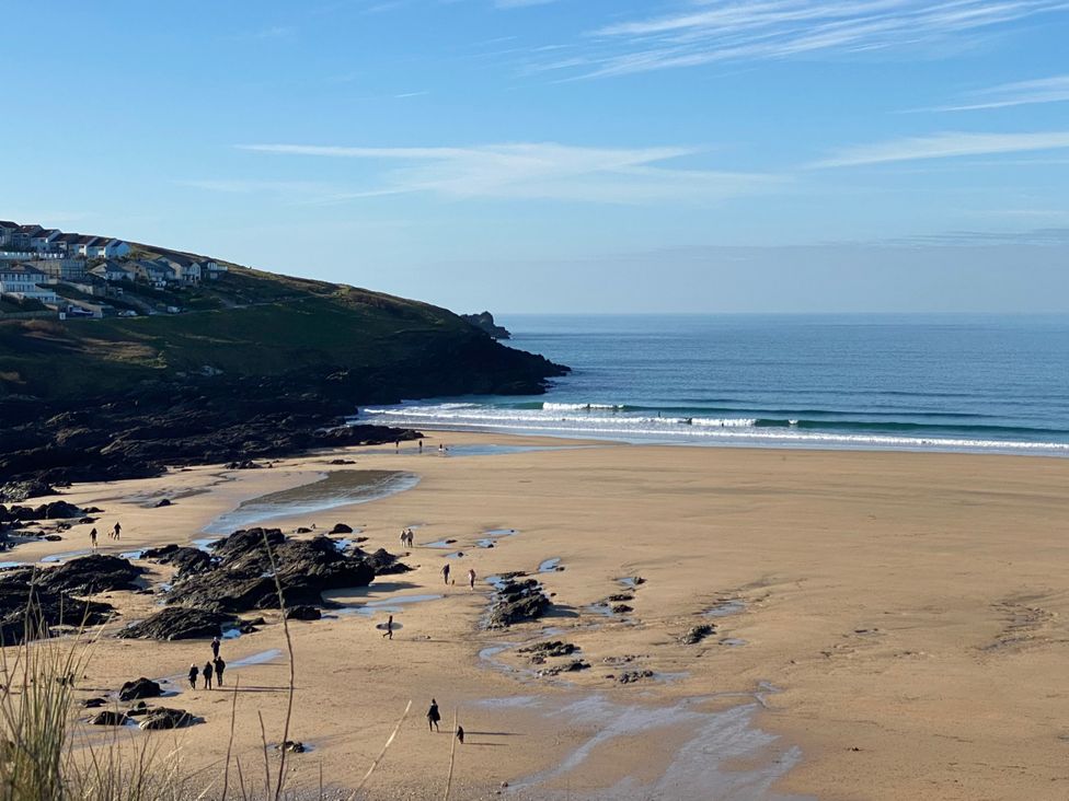 A beach with people walking near the water at Apartment 29 in Newquay