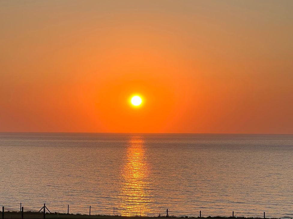 A sunset over the ocean at Apartment 29 in Newquay
