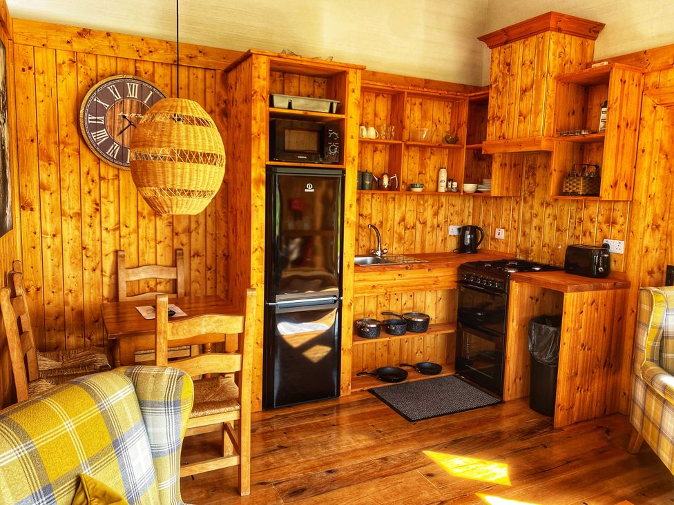 A kitchen with wooden cabinets and furniture at No 4 Enniskillen